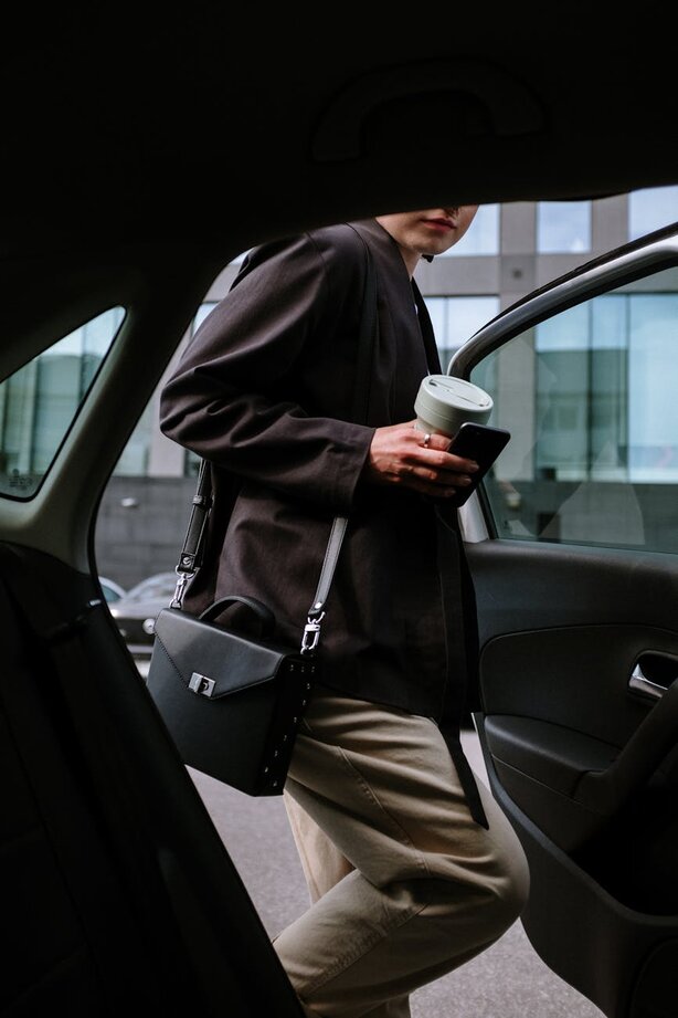 woman in a suit getting into the car