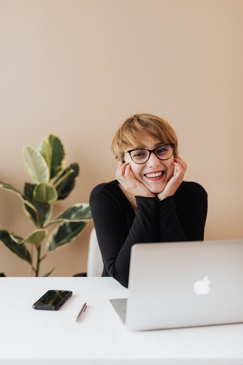 lady with a laptop looking at camera 