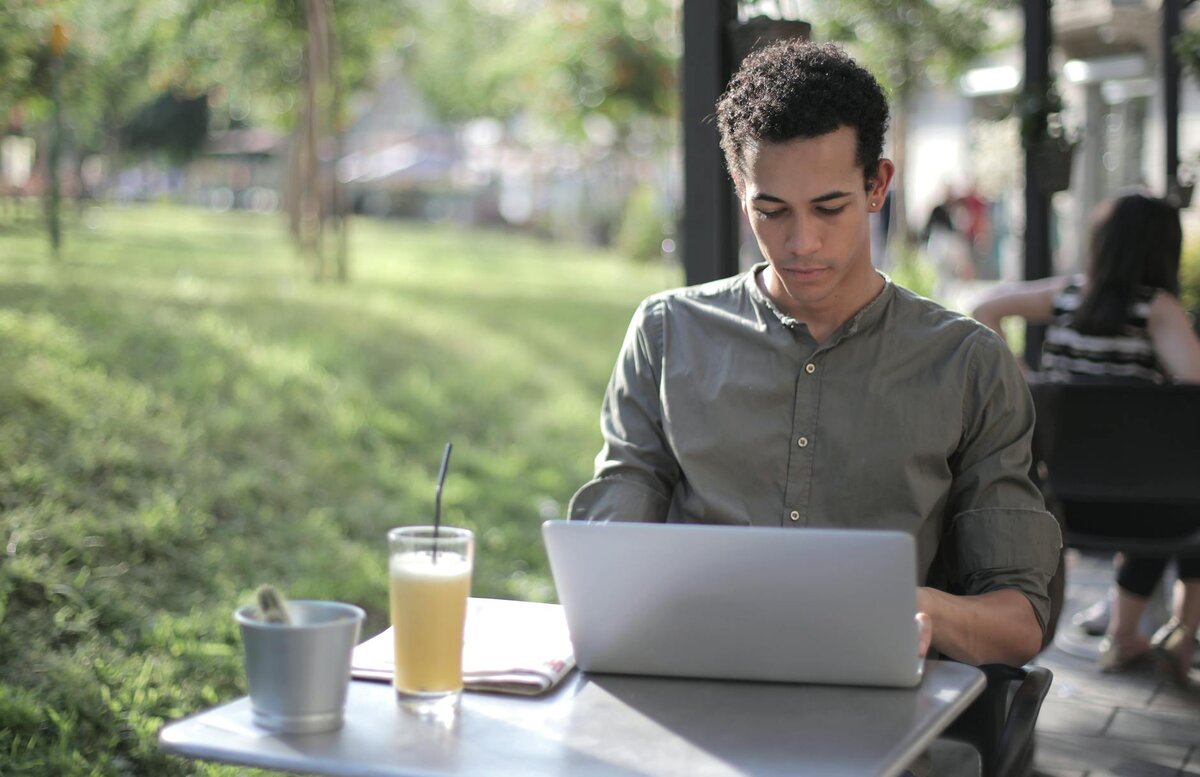 man outside on his laptop