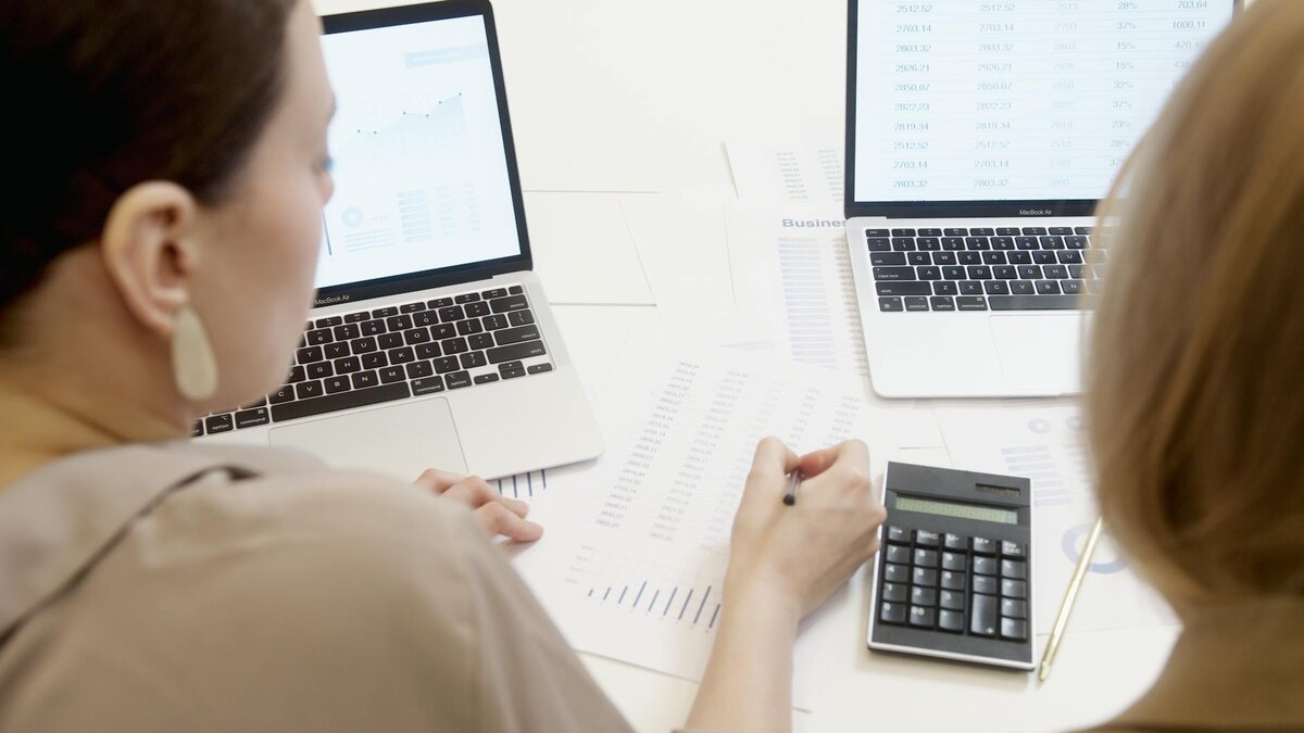 checking data on paper and laptop
