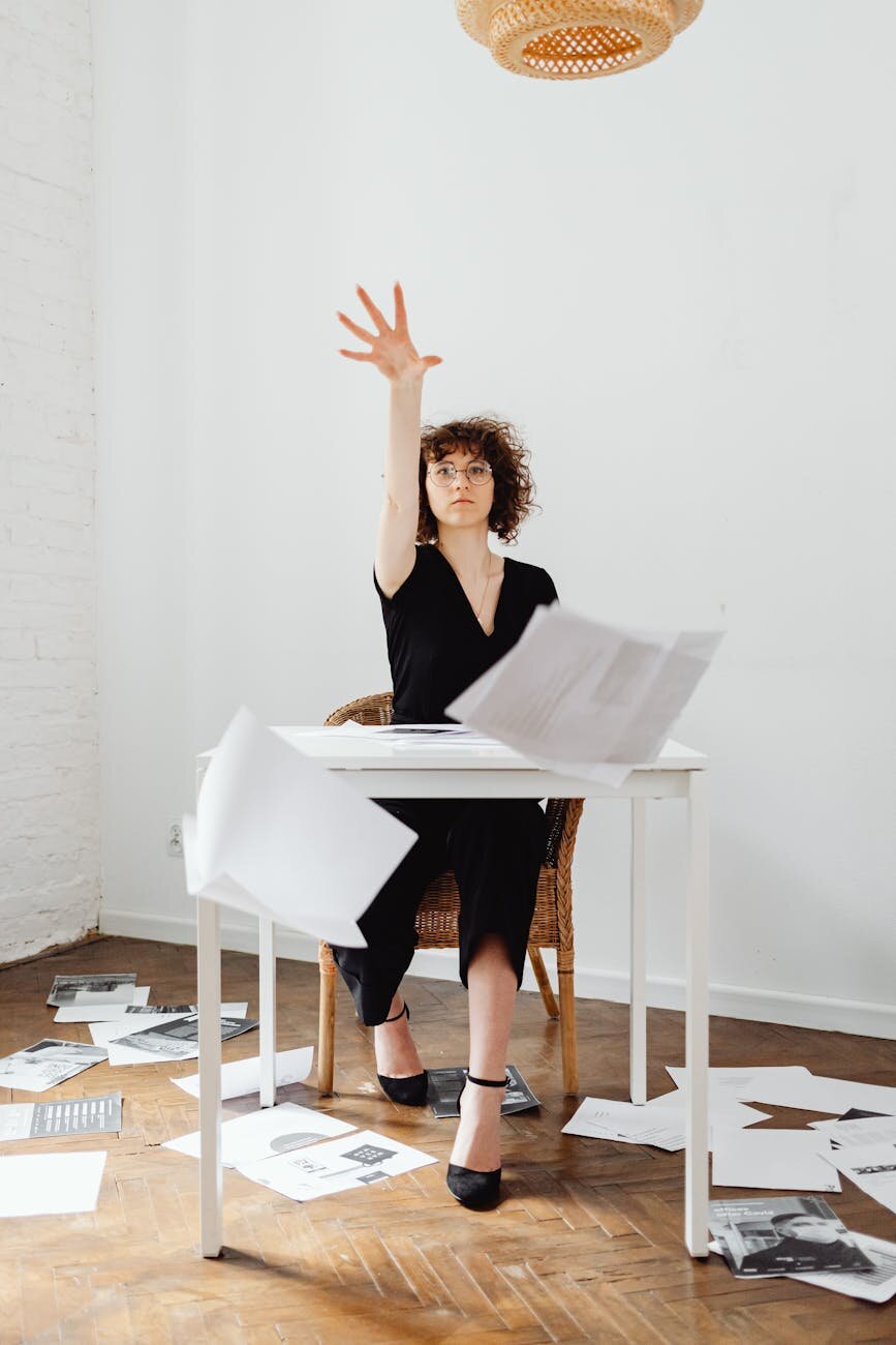 lady throwing papers in air 