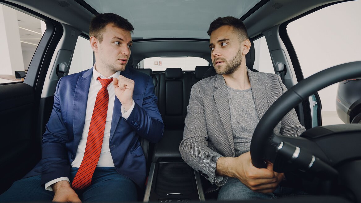 Business owner talking to the a car dealer about the benefit in kind for company cars