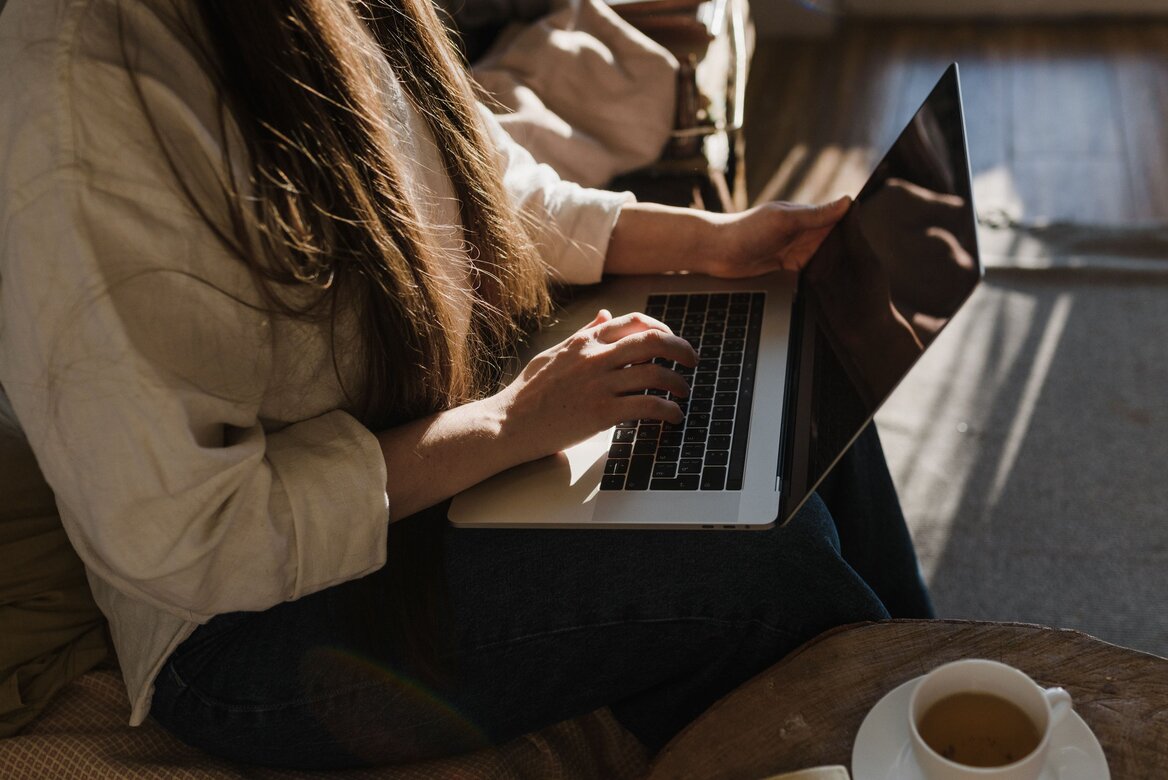 Self-employed woman working on a laptop filing her Self Assessment tax return from home
