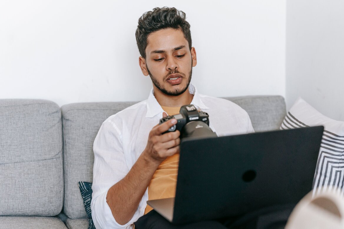 Freelance photographer reviewing wedding photos on a laptop