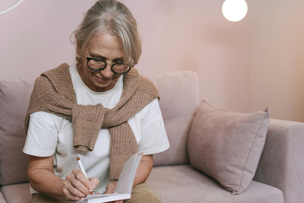 woman writing on her book 