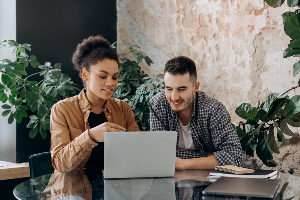 A content creator and accountant reviewing self-assessment tax together on a laptop