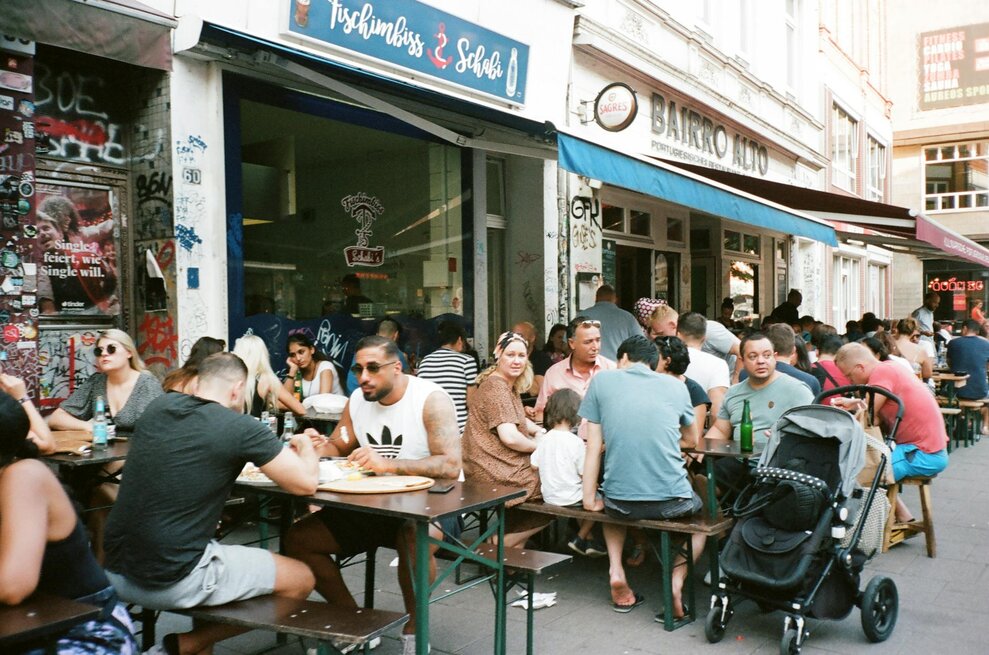 people outside a cafe eating in lisbon