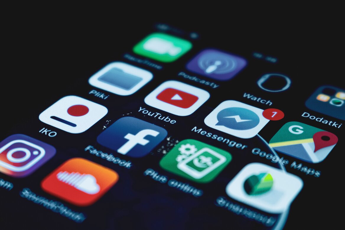 Social media platform icons including YouTube, Instagram and Facebook on a smartphone screen