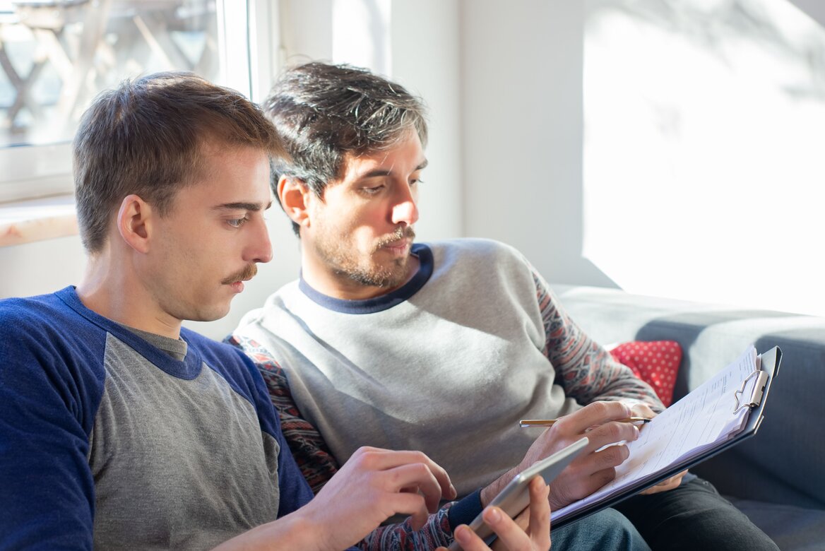  A digital marketer and accountant reviewing financial documents together