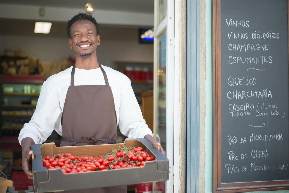 man with strawberry's outside work 