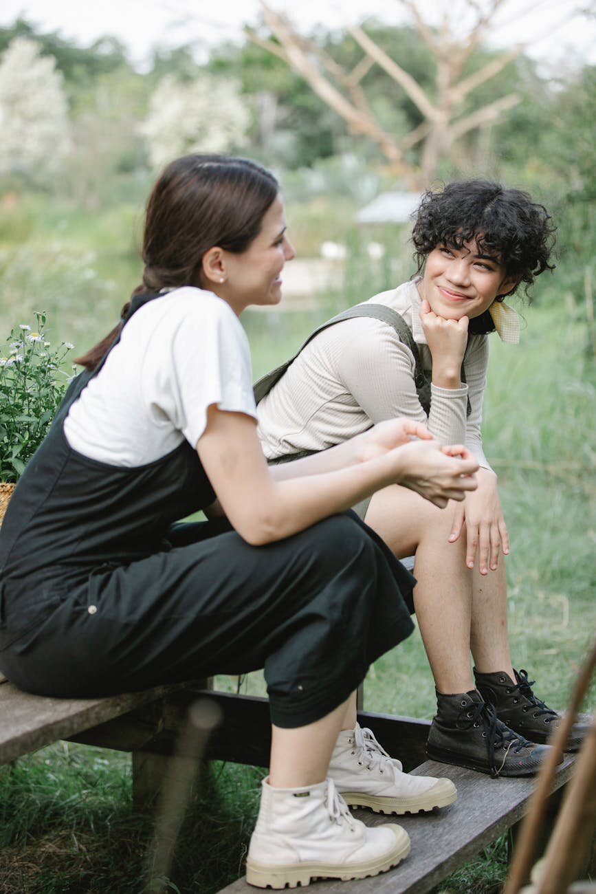 Two people sitting on a bench 