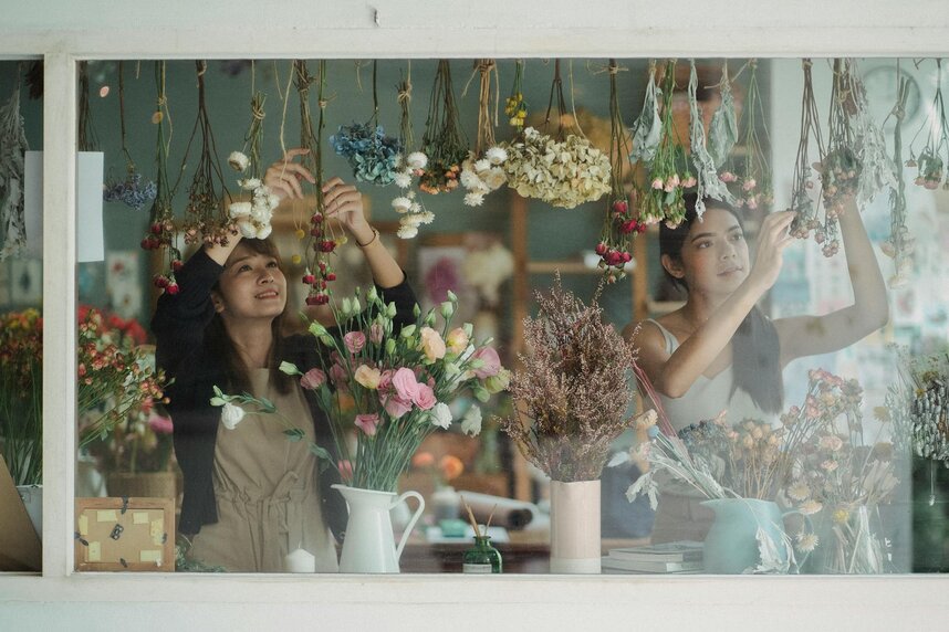 two lady's hanging flowers 