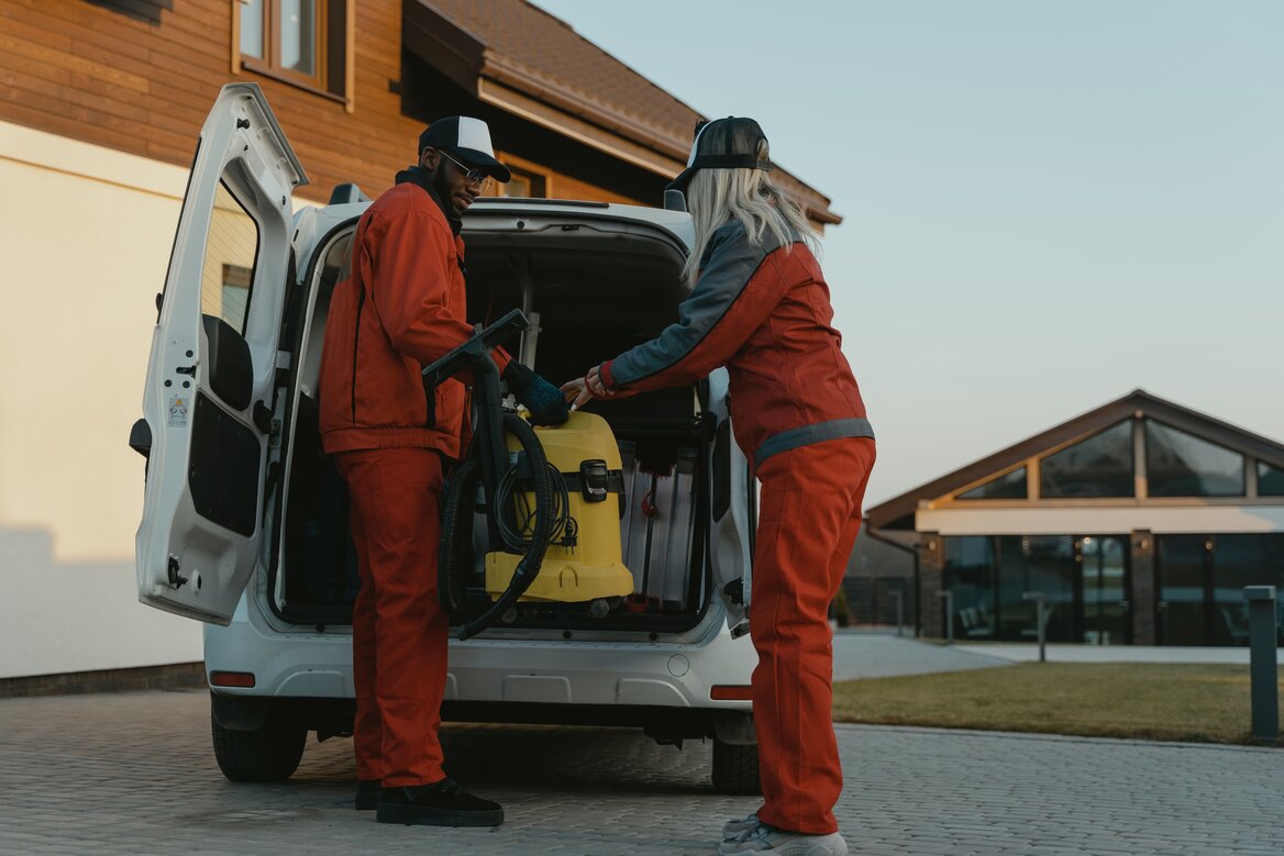 Company vehicle is being unloaded by two employees