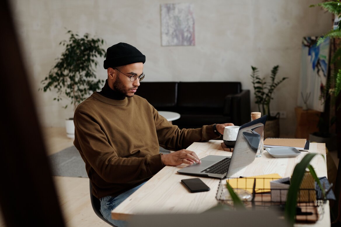 Man reviewing financial documents on a laptop for digital tax submission
