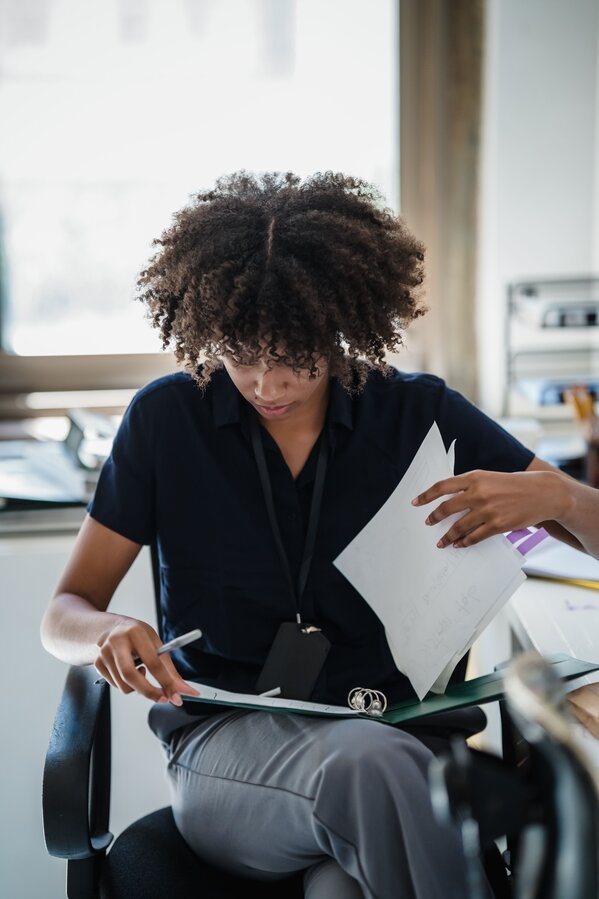 Man using a phone for assessing income breaches