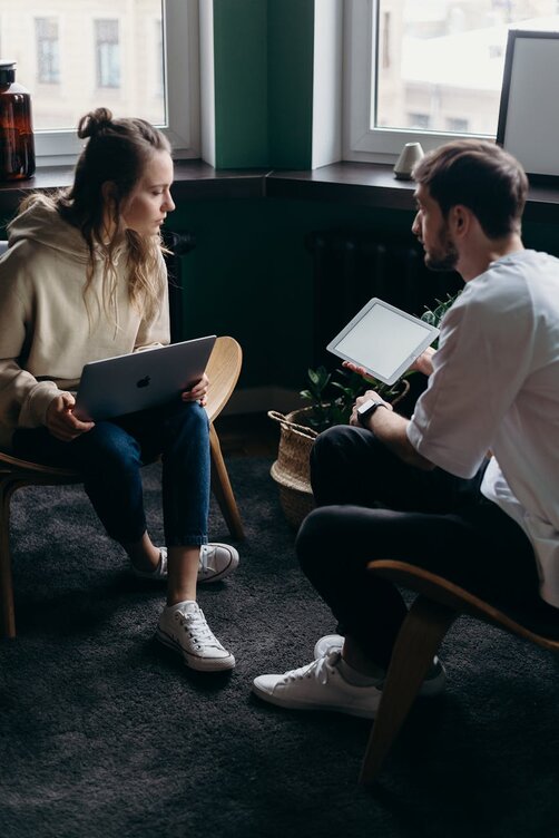 two people looking at a laptop 