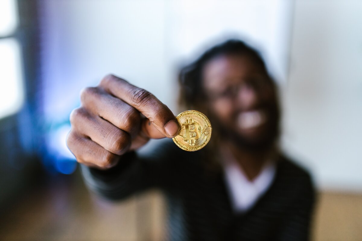 Man holding a crypto currency coin
