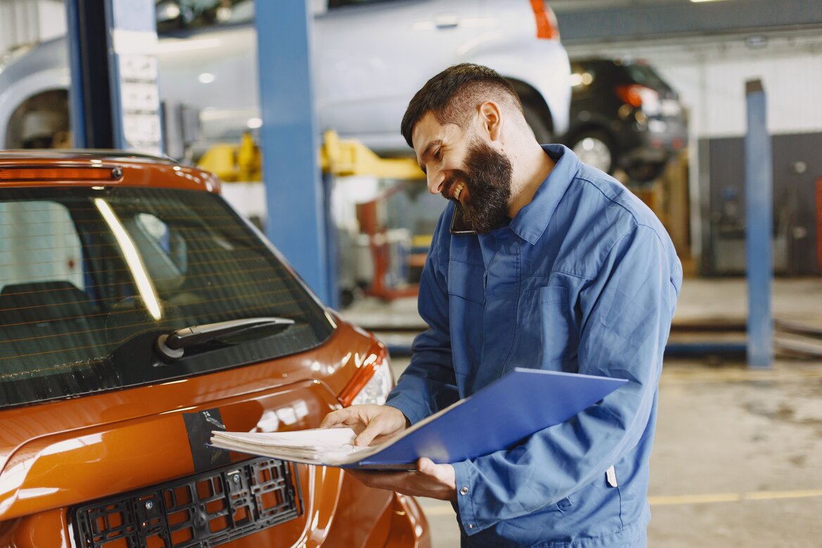An engineer checking the mileage log of a company vehicle