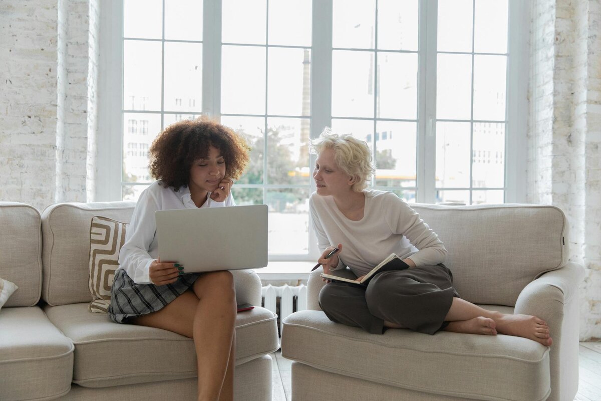 two people looking at a laptop