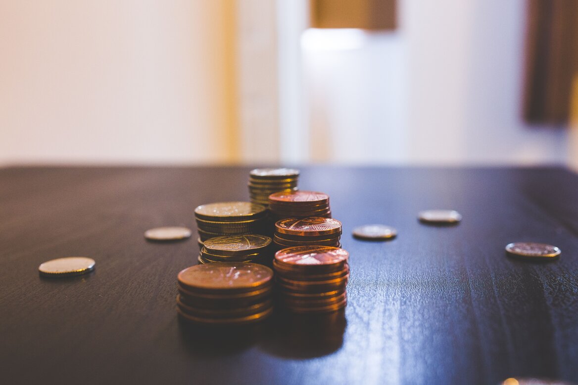 Small stacks of coins representing the £1,000 tax-free trading allowance threshold