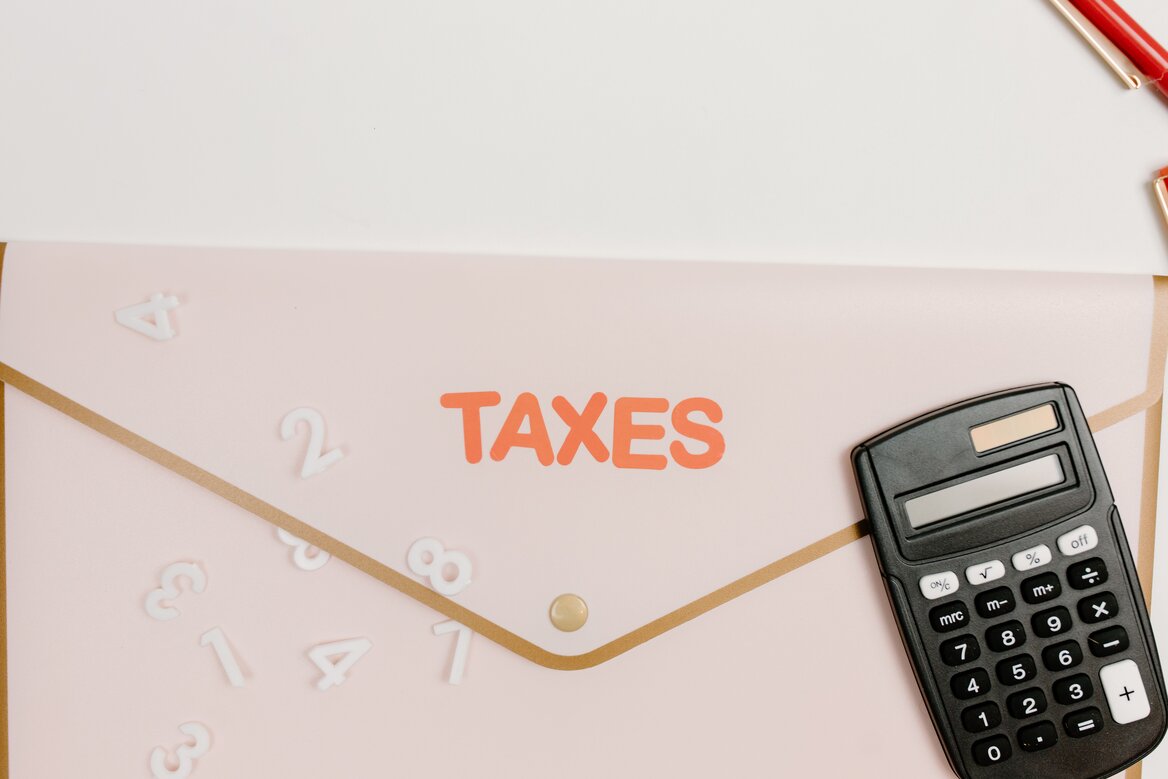 Calculator and taxes folder used to check an HMRC tax code