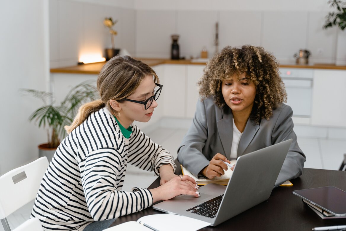 Two women engaged in a discussion about digital tax letters
