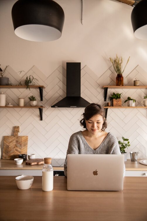 lady on a laptop in a kitchen