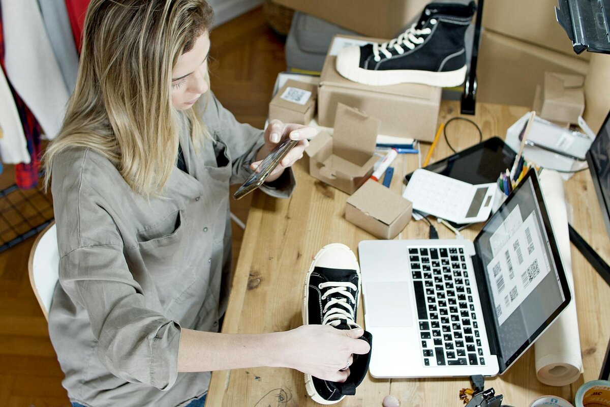 woman taking a photo of shoes