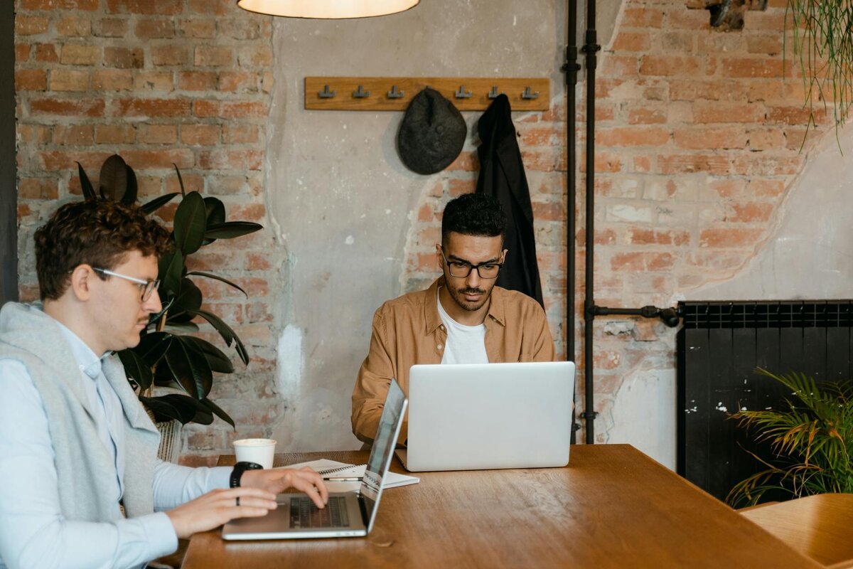two men working on their laptops
