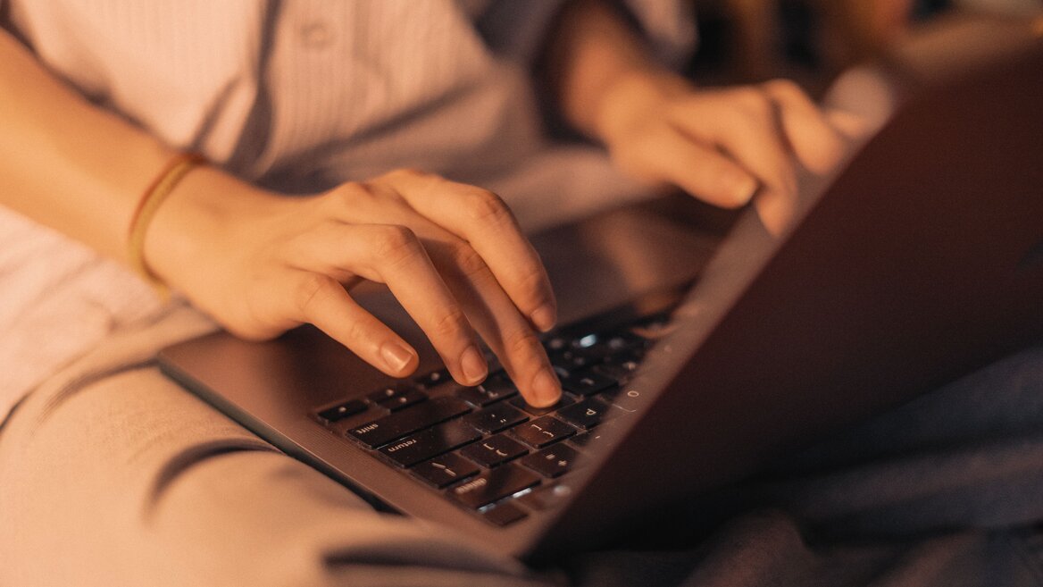 Taxpayer using a laptop to review documents for digital tax reporting
