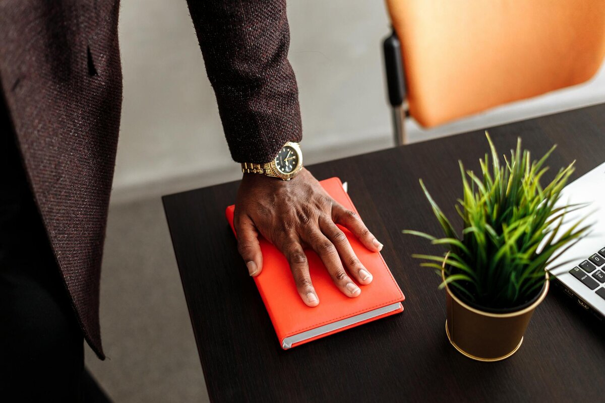 man with hand on book