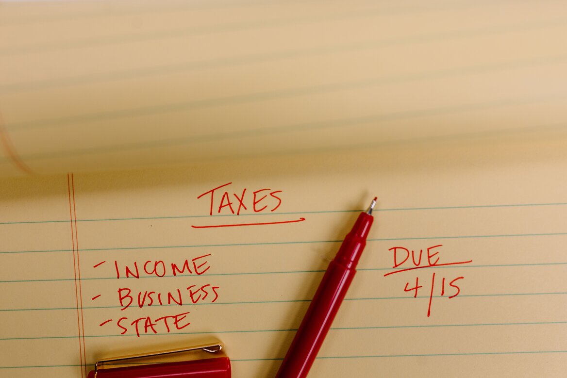 Handwritten notes listing income, business, and tax categories for bookkeeping records