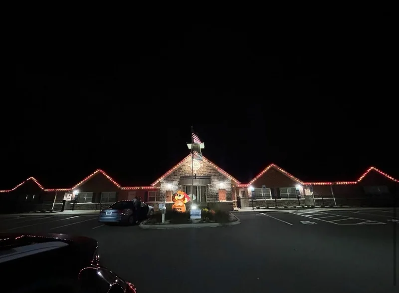 Suburban house decorated with multicolor roofline lights
