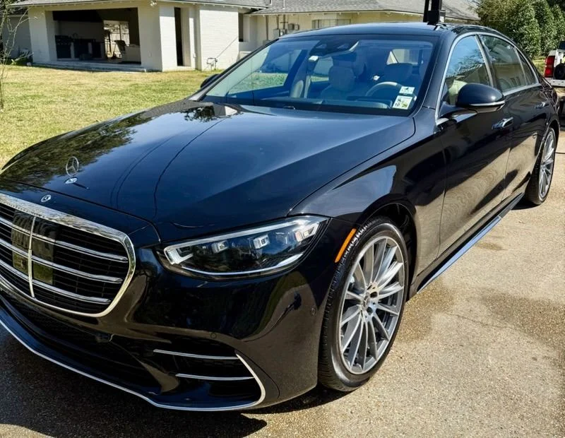 Black Mercedes-Benz S-Class sedan with a glossy, professionally detailed finish