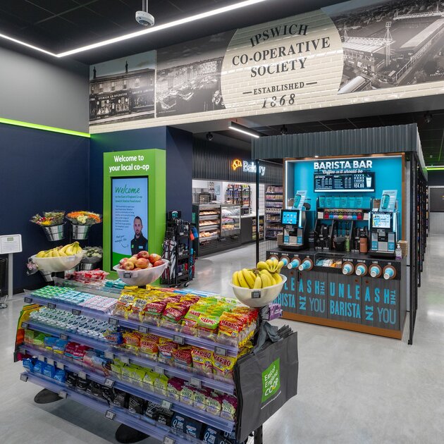 Interior of East of England Co-op store with café area and modern retail displays.