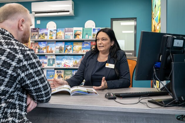 East of England Co-op colleague assisting a customer at checkout, showcasing customer service role.