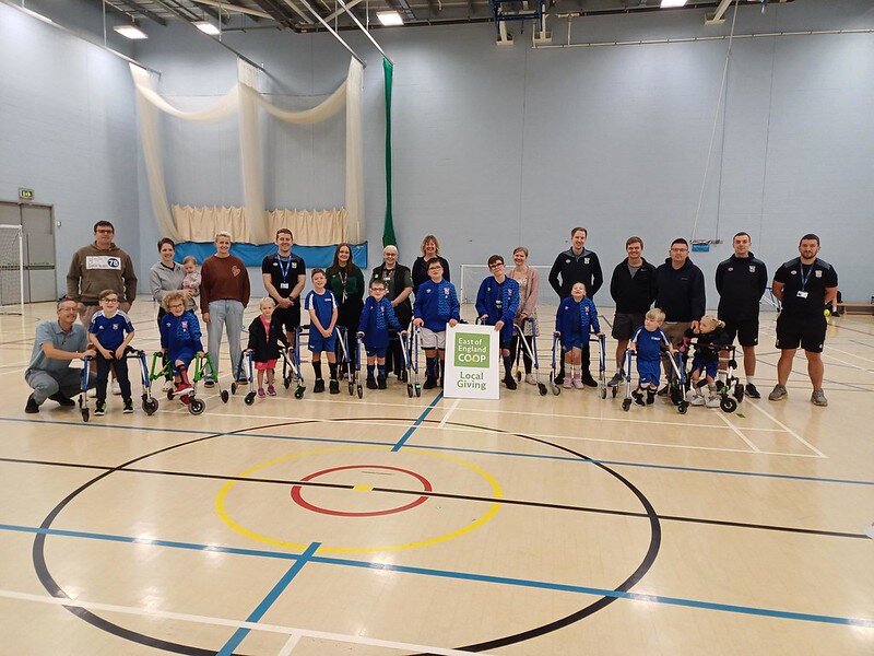 Customer making a £10 East of England Co-op foodbank donation at the checkout using contactless payment.