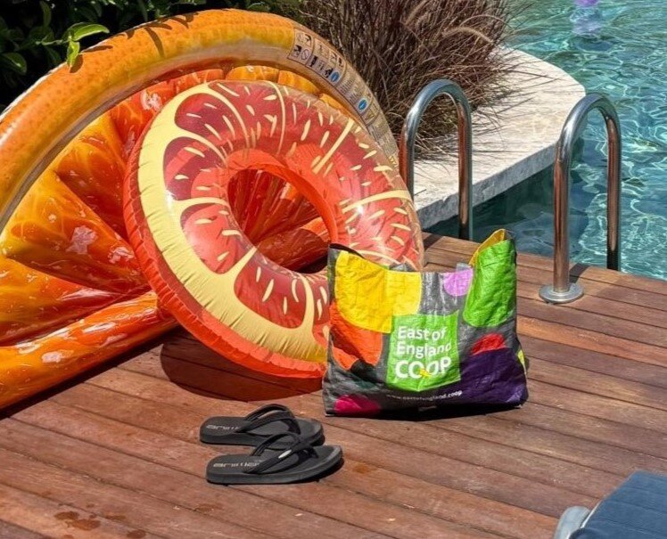 East of England Co-op branded bag beside swimming pool