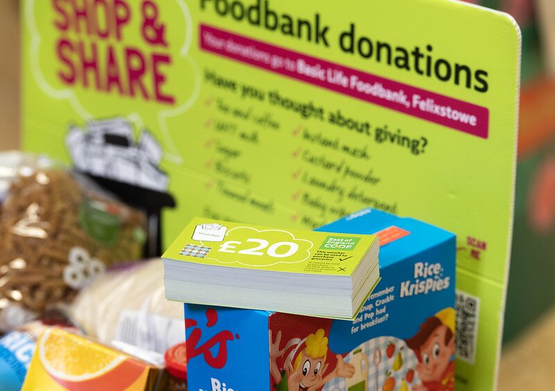 Customer making a £10 East of England Co-op foodbank donation at the checkout using contactless payment.
