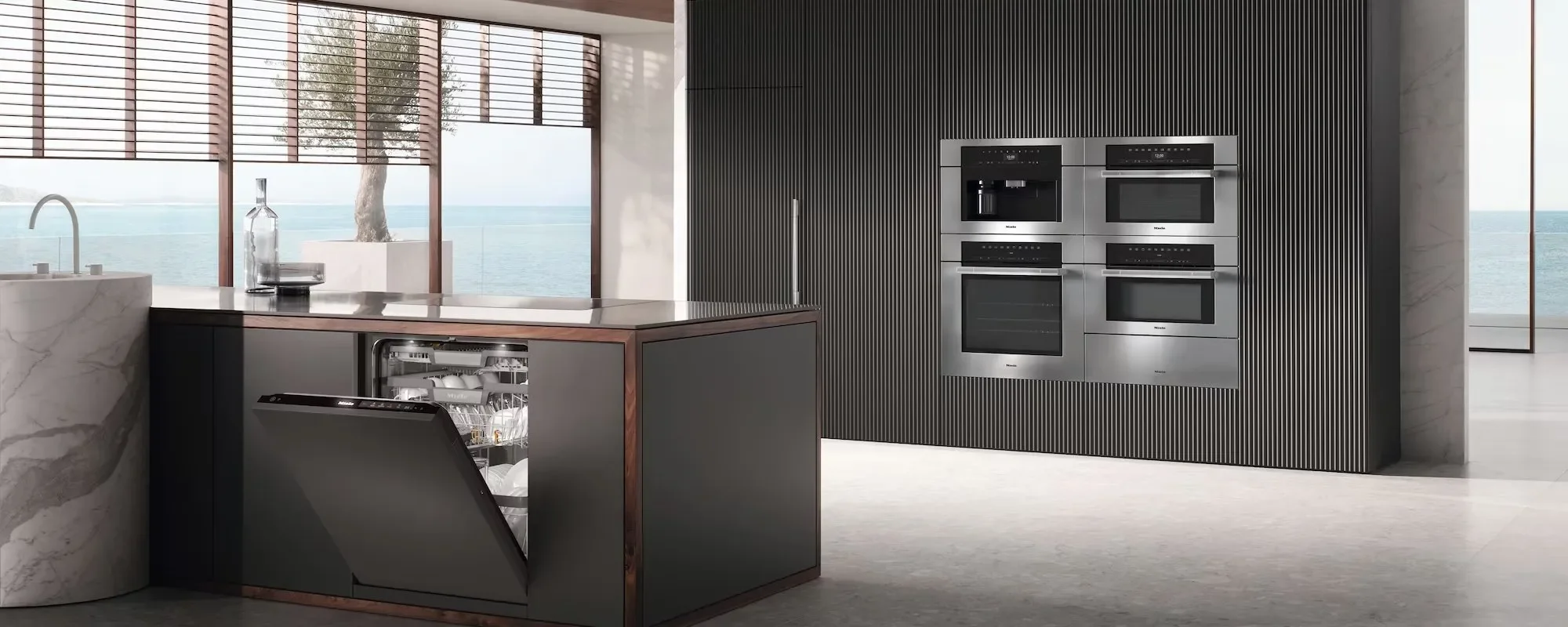 Image of a scene showing Miele 24 inch Dishwasher with Hidden Controls and Miele 30 inch Convection Wall Oven and Miele 30 inch Combi-Steam Oven with Convection and Miele 30 inch Convection Wall Oven and Miele 30 inch Warming Drawer