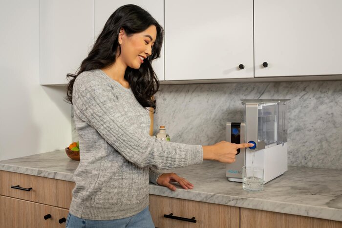 woman enjoying AquaTru Water
