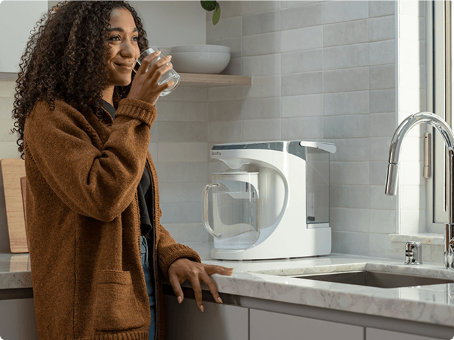 Lady enjoying water with Carafe unit