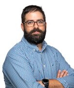 Photo of Michael Bezembinder, in a light blue shirt overlooking a white silhouette