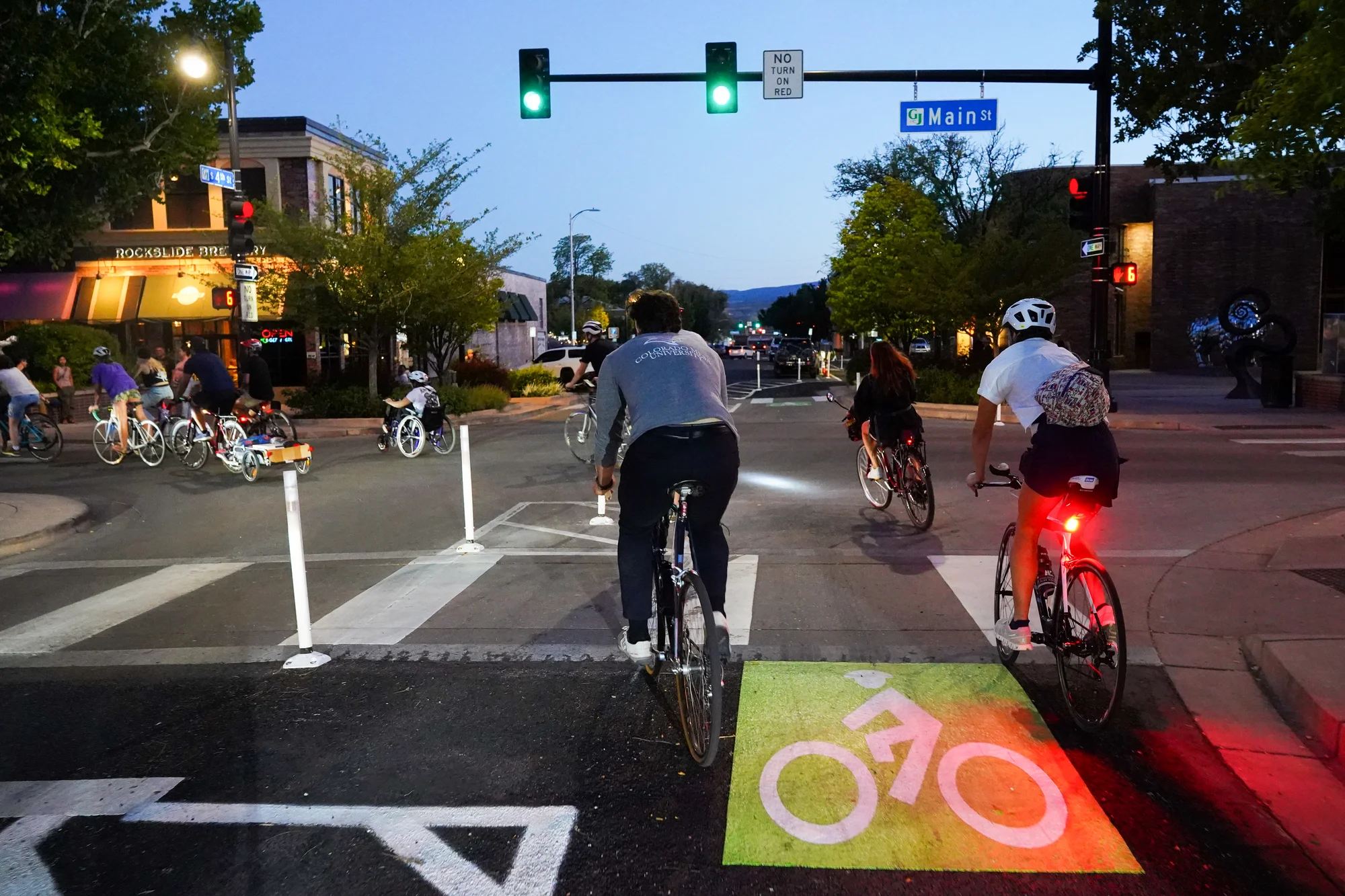 Cyclists navigate the turn on to Main Street from the bike lane, newly buffered by plastic posts. Photo: Joshua Vorse, Rocky Mountain PBS