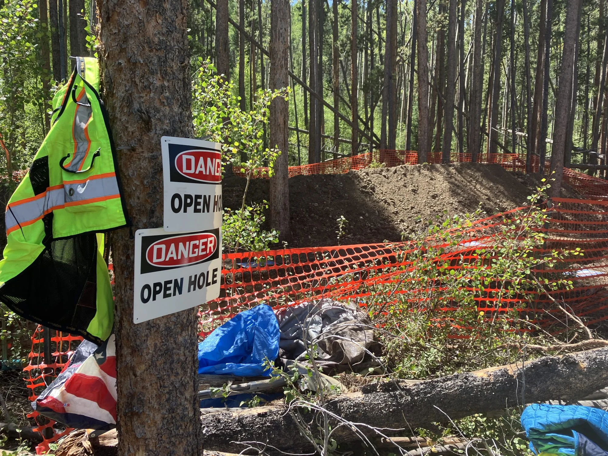 Signs state “danger open hole” near the site of a trench dug by U.S. Geological Survey scientists. The scientists are studying the Gore Range fault and an ancient earthquake that might have occurred here. Photo: Ryan Spencer, Summit Daily News