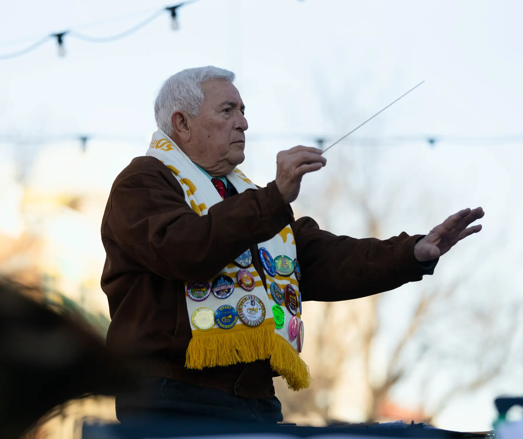 Cecil Gutierrez, 78, a former band director and mayor of Loveland, directs the tuba players. Photo: Cormac McCrimmon, Rocky Mountain PBS