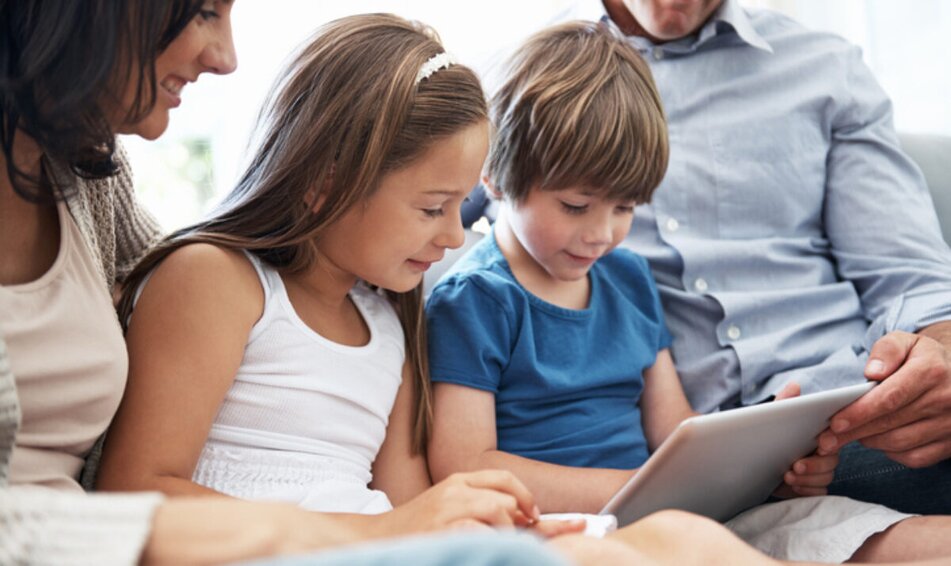 Children looking at screen with parents