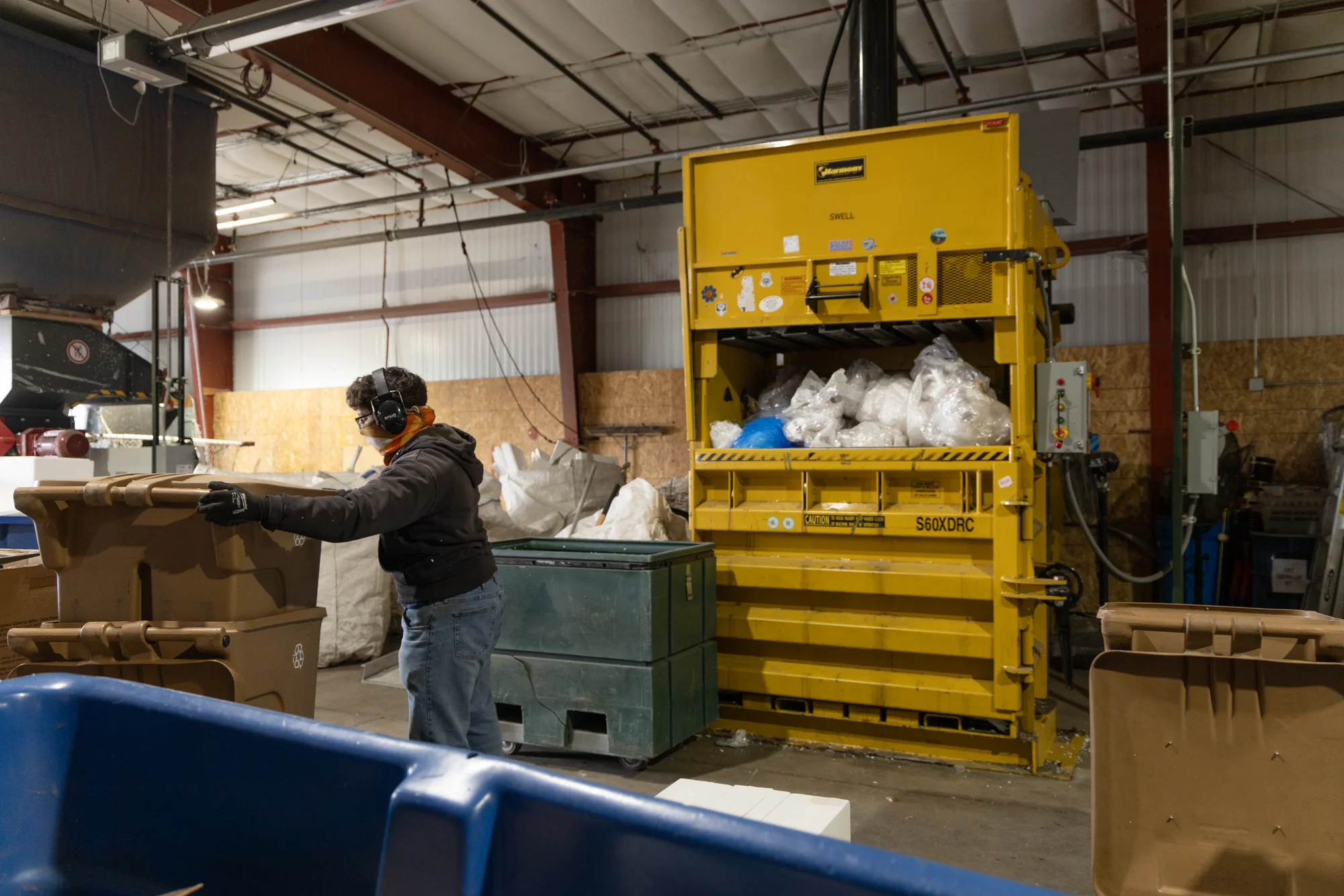 An employee condenses thin plastic film at Eco-Cycle’s Center for Hard-to-Recycle Materials. Plastic film is often recycled as Trex decking, a decking material made from recycled plastic and wood.   Photo by Andrea Kramar, Rocky Mountain PBS