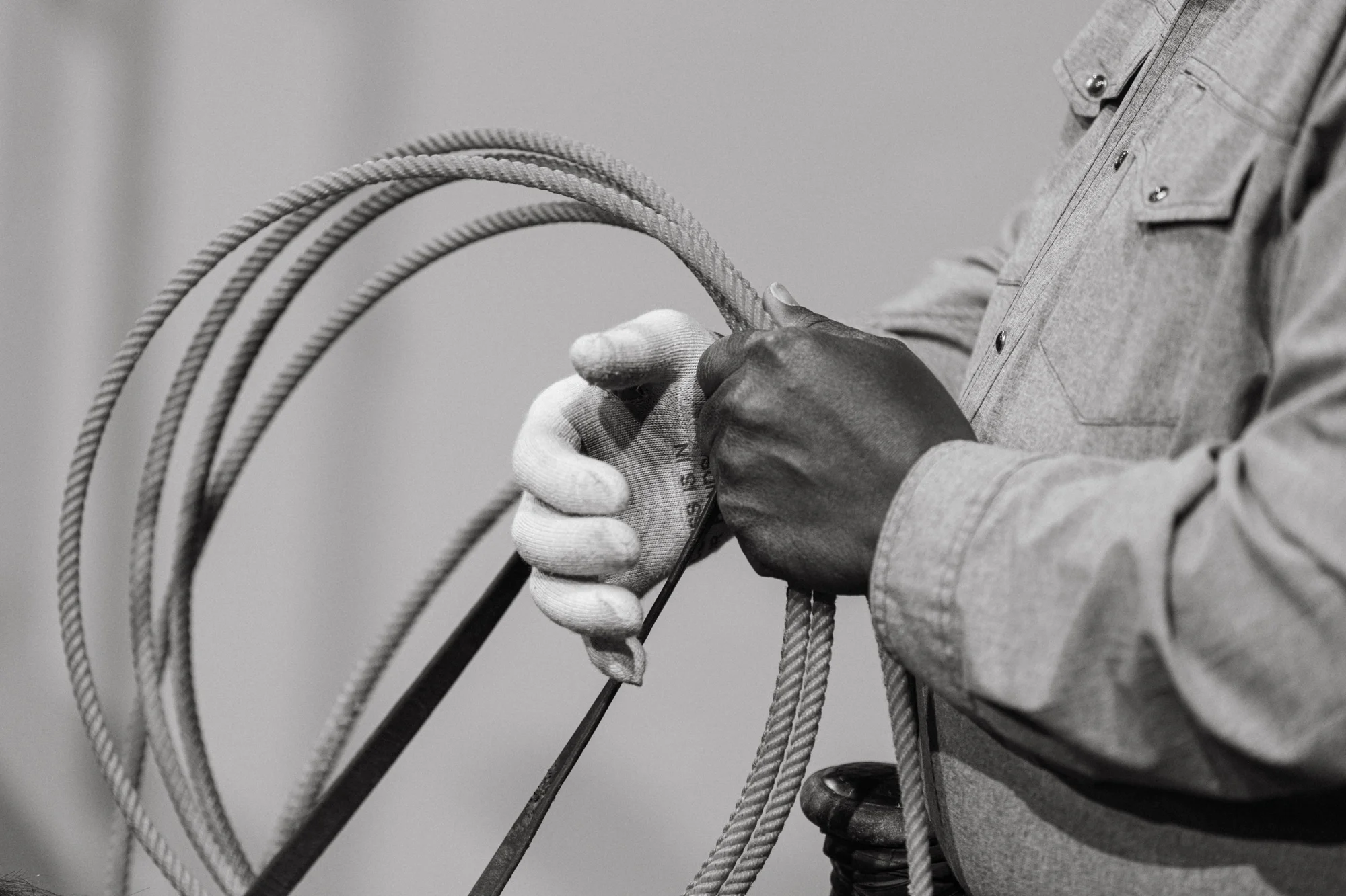 A cowboy preps his lasso before entering the arena. Photo: Peter Vo, Rocky Mountain PBS