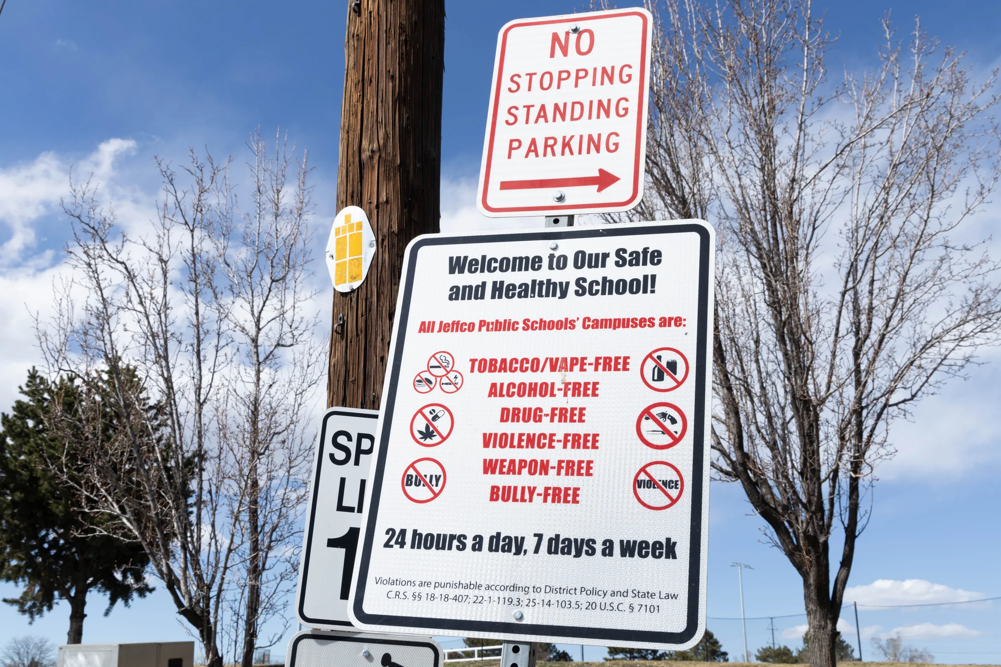 A school district sign outside Lakewood High School prohibits bullying. Kott, who teaches 11th grade at the school, said she’s seen bullying reach unprecedented highs since Trump was elected for his second term in November.  Photo: Andrea Kramar, Rocky Mountain PBS